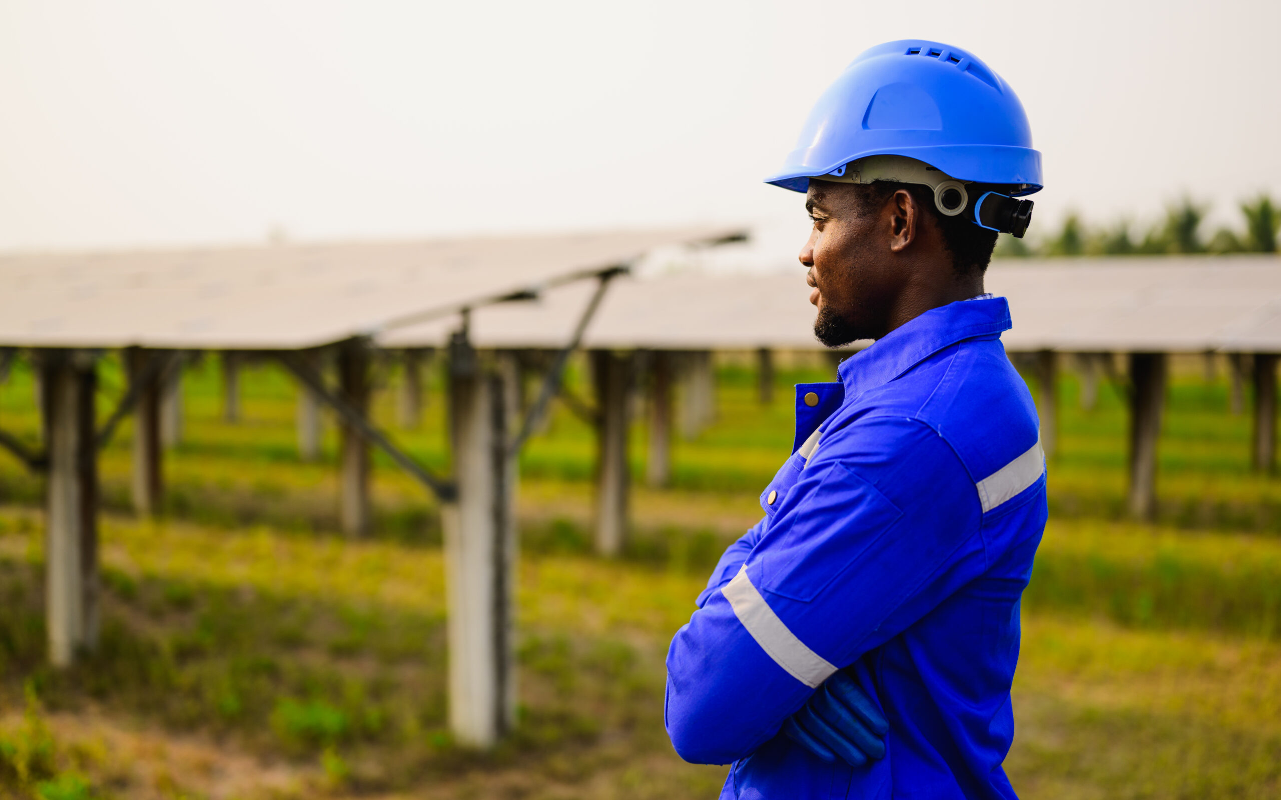maintenance engineer installing solar panels on solar cell farm